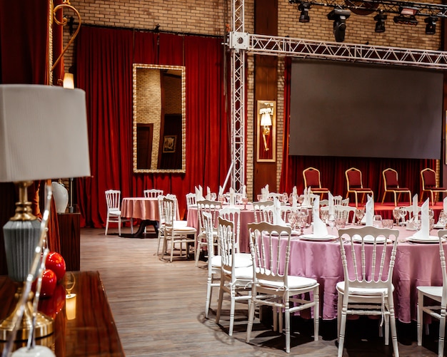 Classic restaurant witn red curtains and stage