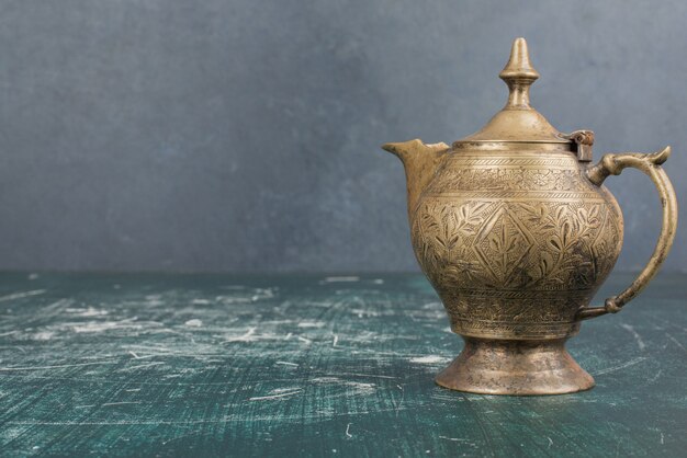 Classic teapot isolated on marble table.