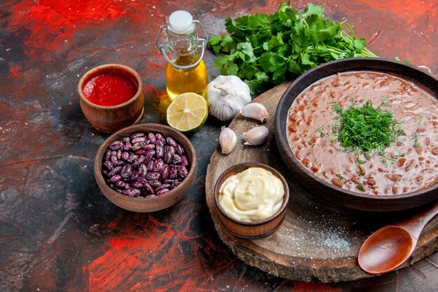 Classic tomato soap beans garlic spoon on cutting board oil bottle lemon ketchup and mayonnaise