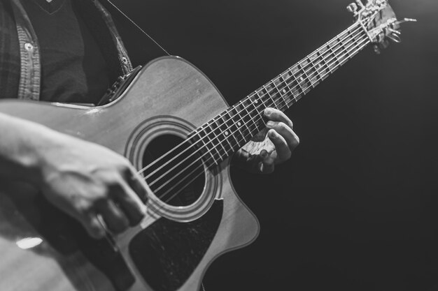 Classical acoustic guitar in the hands of a musician copy space.