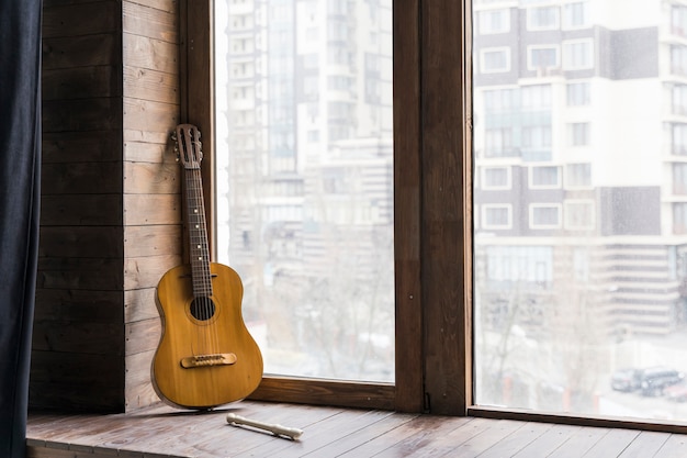Classical guitar and modern city urban apartment