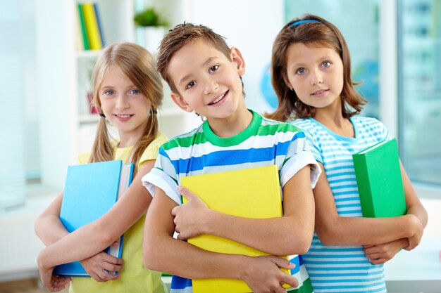 Classmates holding folders