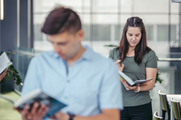 Classmates standing and reading