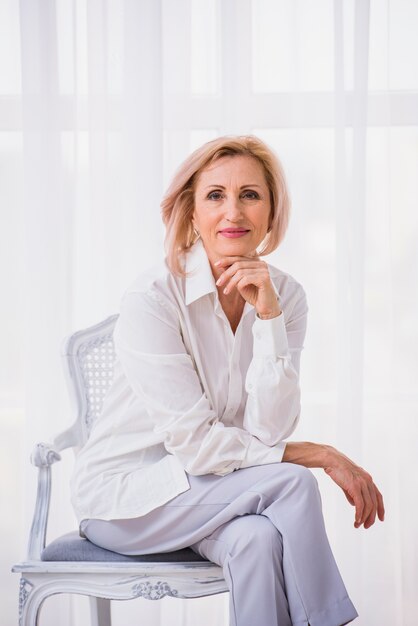 Classy woman sitting on chair 