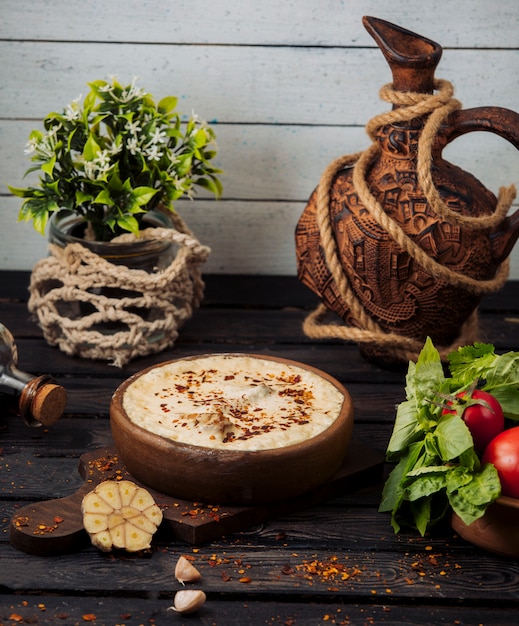 Clay pot with meat covered in melted cheese