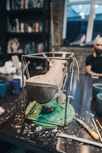 clay whale on a stand in a pottery workshop