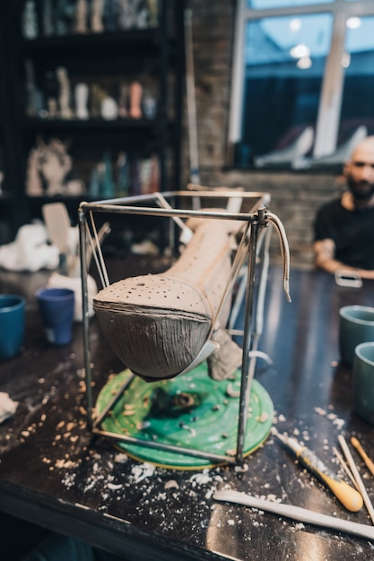 Free photo clay whale on a stand in a pottery workshop