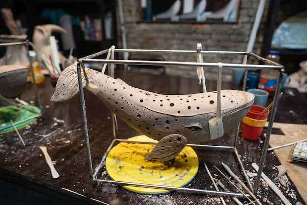 Clay whale on a stand in a pottery workshop