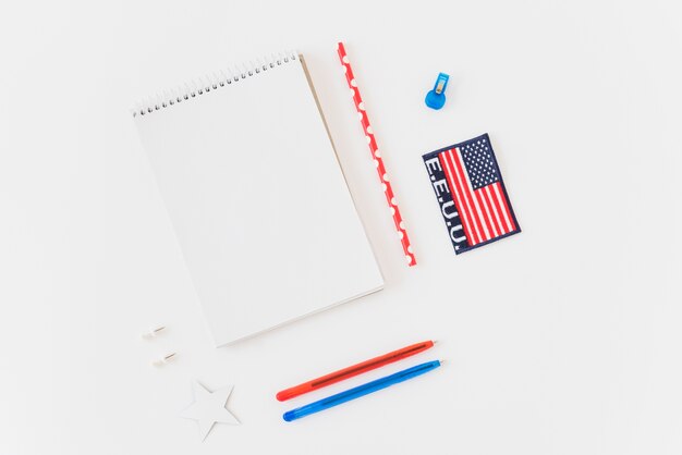 Clean notebook with pens and American flag