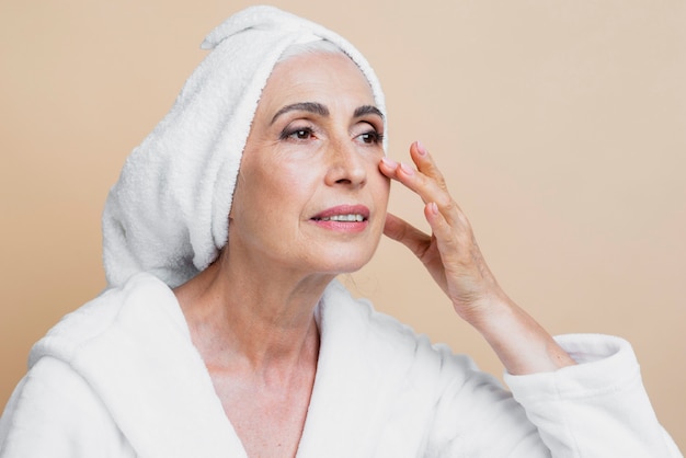 Free photo clean senior woman in bathrobe