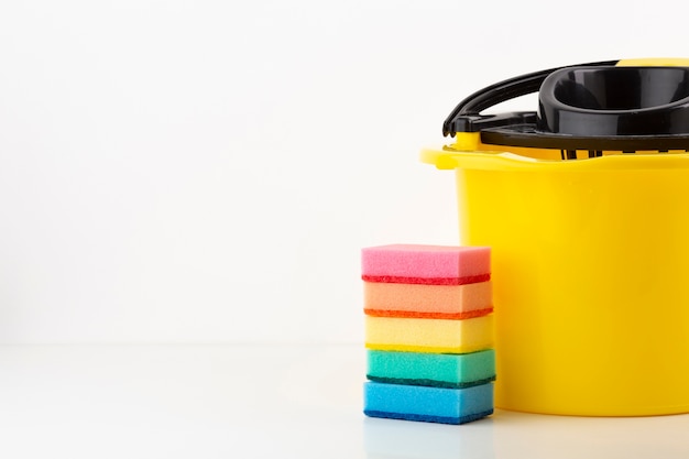 Free photo cleaning bucket with colorful sponges