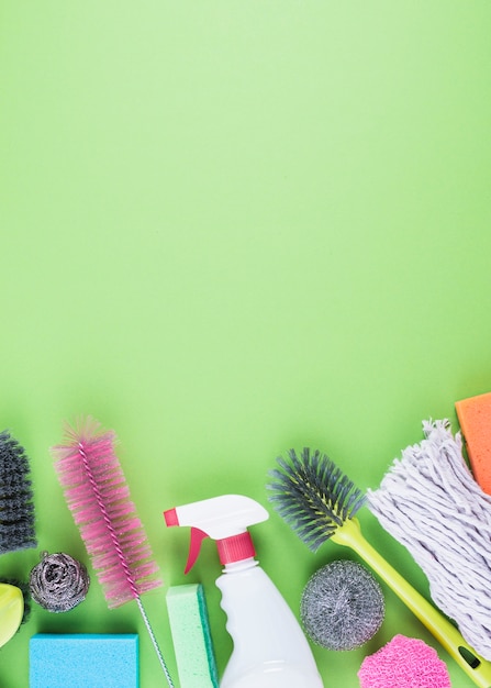 Cleaning equipments at the bottom of green background