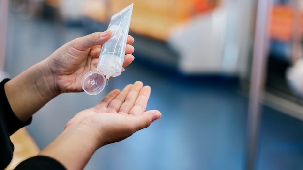 Cleaning hands with a hand sanitizer gel to prevent coronavirus contamination