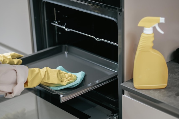 Free photo cleaning the kitchen. housewife in yellow gloves cleaning the kitchen