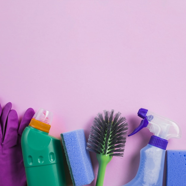 Cleaning products at the bottom of pink background