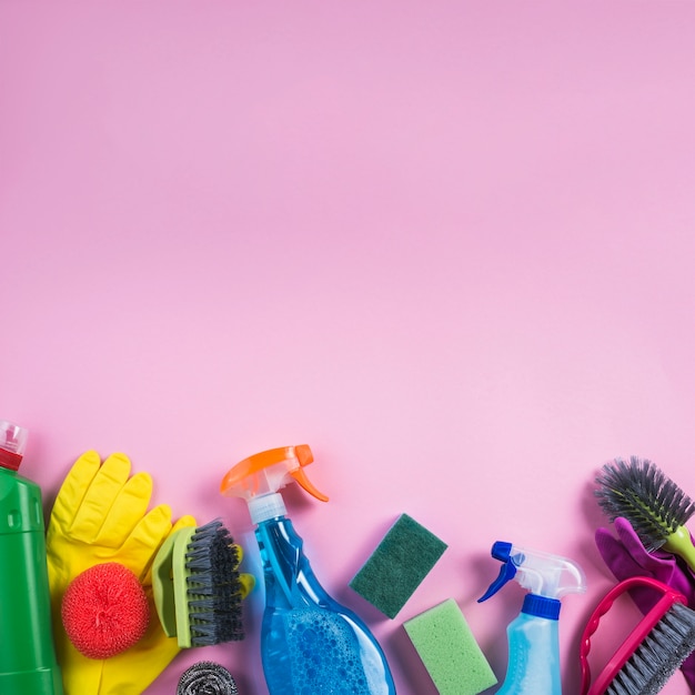 Cleaning products at the edge of pink backdrop