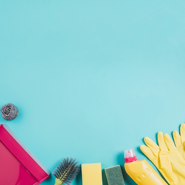 Cleaning products on turquoise background