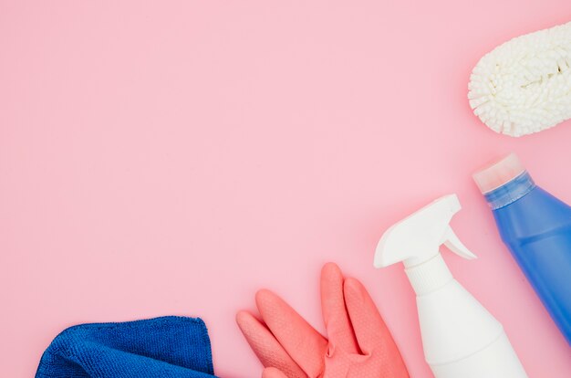 Cleaning supplies on pink background