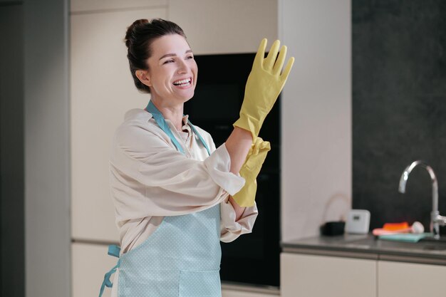 Cleaning. Young dark-haired woman cleaning in the kitchen