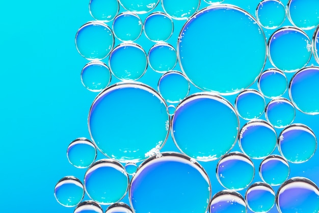 Clear air bubbles on azure background