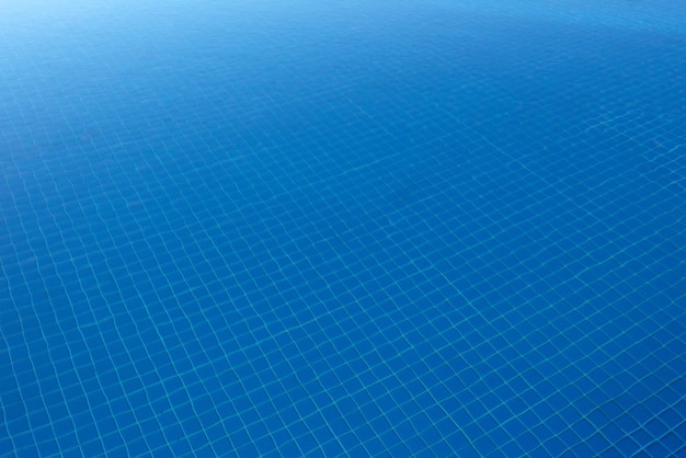 Free photo clear blue water in the pool, through the sunlight. water background.