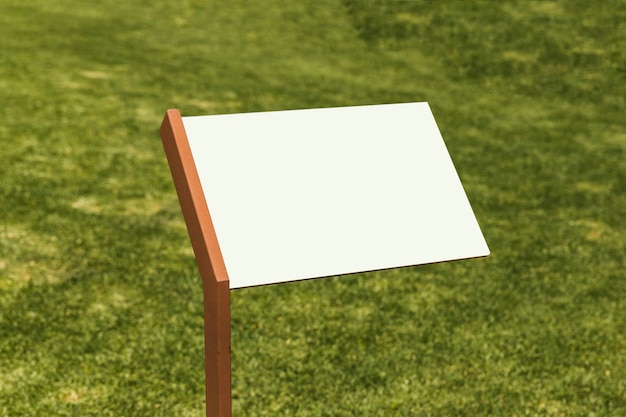 Free photo clear information signboard on green grass