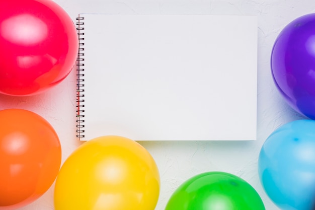 Clear notebook and colorful balloons 