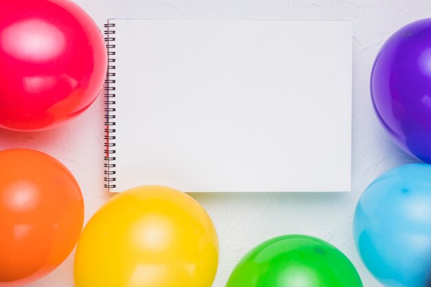 Clear notebook and colorful balloons 