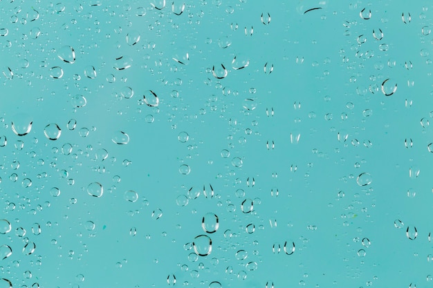 Clear water drops on turquoise background