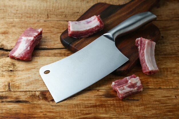 cleaver knife and ribs on wooden board