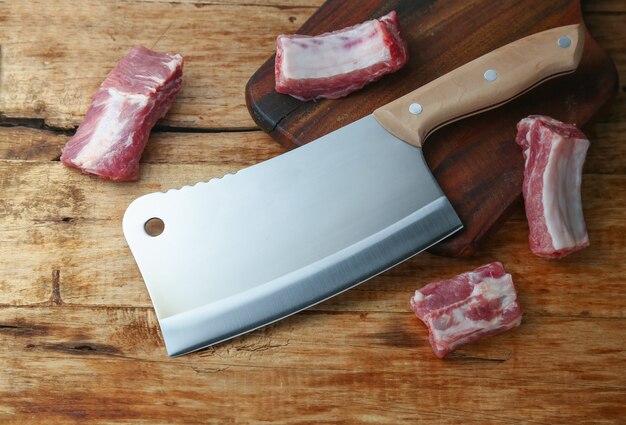 cleaver knife and ribs on wooden board