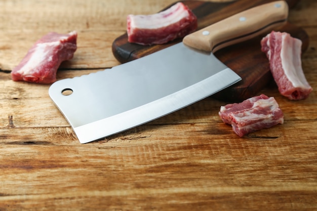 cleaver knife and ribs on wooden board