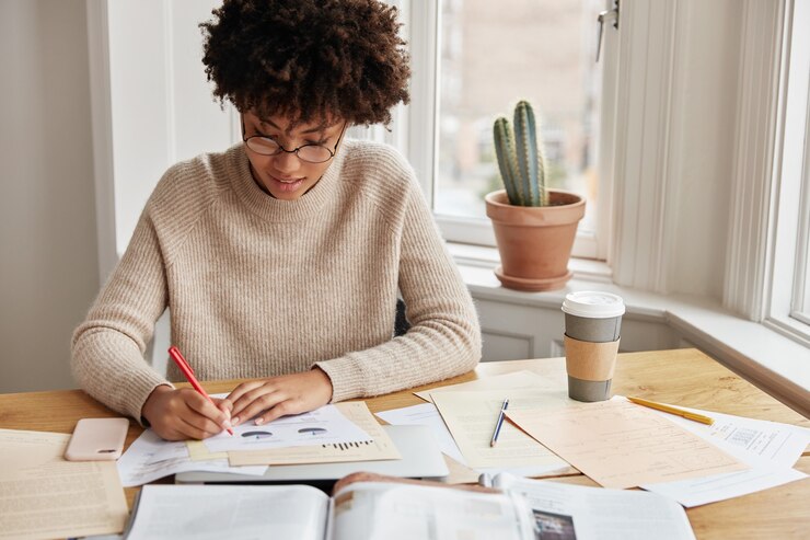 Free Photo clever busy young woman accountant working at home