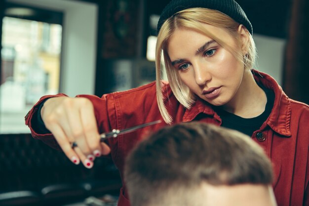 Client during beard shaving in barbershop.