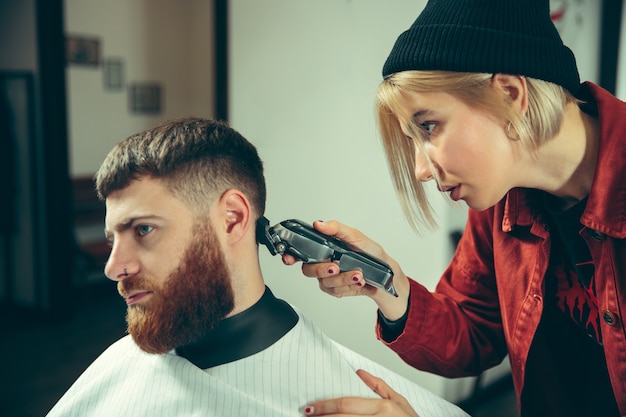 Client during beard shaving in barbershop