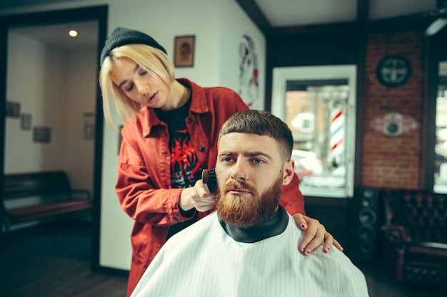 Client during beard shaving in barbershop