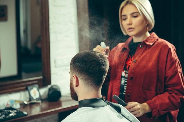 Client during beard shaving in barbershop