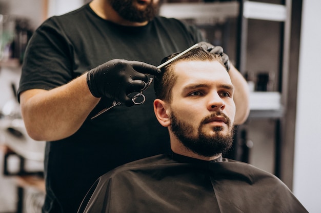 Client doing hair cut at a barber shop salon