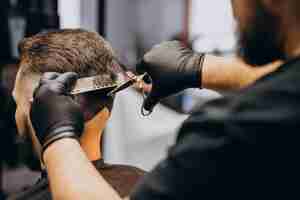 Free photo client doing hair cut at a barber shop salon