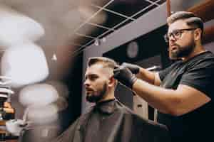 Free photo client doing hair cut at a barber shop salon