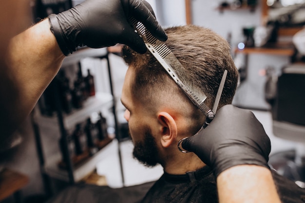 Client doing hair cut at a barber shop salon