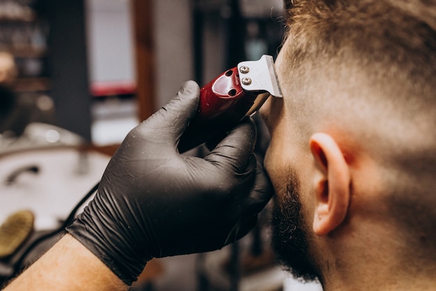 Client doing hair cut at a barber shop salon