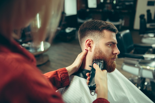 Client during beard shaving in barbershop