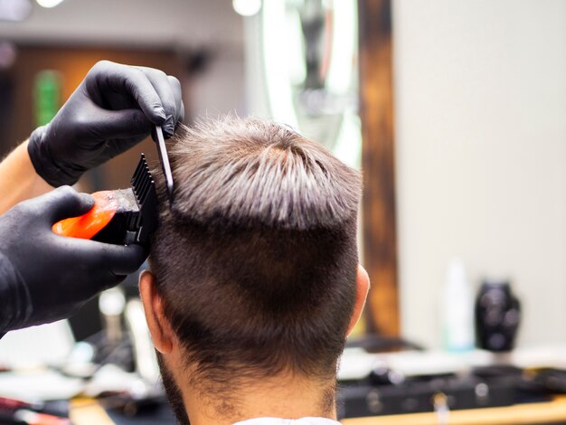 Client getting a new haircut from behind