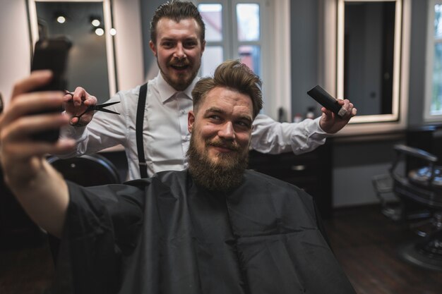 Client and hairdresser posing for selfie