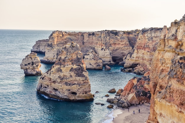 Free photo cliffs sticking out of the water during daytime