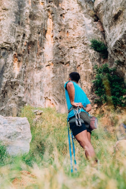 Climber in front of cliffs