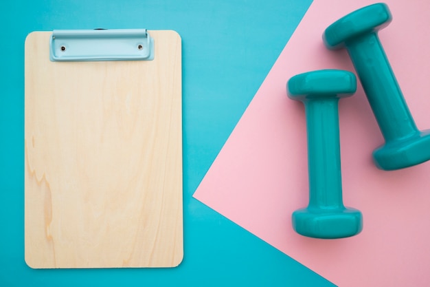 Clipboard and dumbbells
