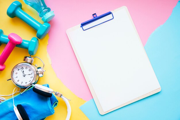 Clipboard near pile of sports equipment