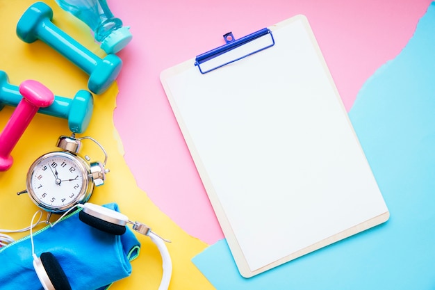 Clipboard near pile of sports equipment